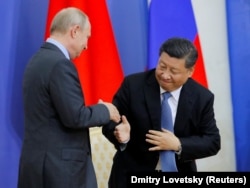 Chinese President Xi Jinping (right) and Russian President Vladimir Putin at the St. Petersburg International Economic Forum in St. Petersburg on June 6.