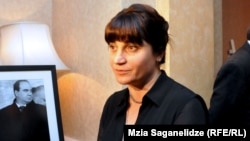 Zurab Zhvania's wife Nino Kadagidze beside a picture of her late husband. (file photo)