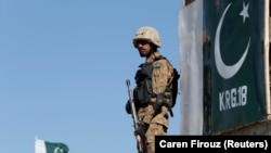 A Pakistani soldier stands guard at an outpost in the town of Angoor Adda near the Afghan border area targeted by air strikes on December 24. (file photo)