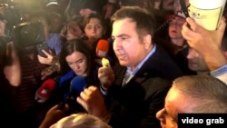 Mikheil Saakashvili speaks to reporters after crossing the Polish-Ukrainian border on September 10.