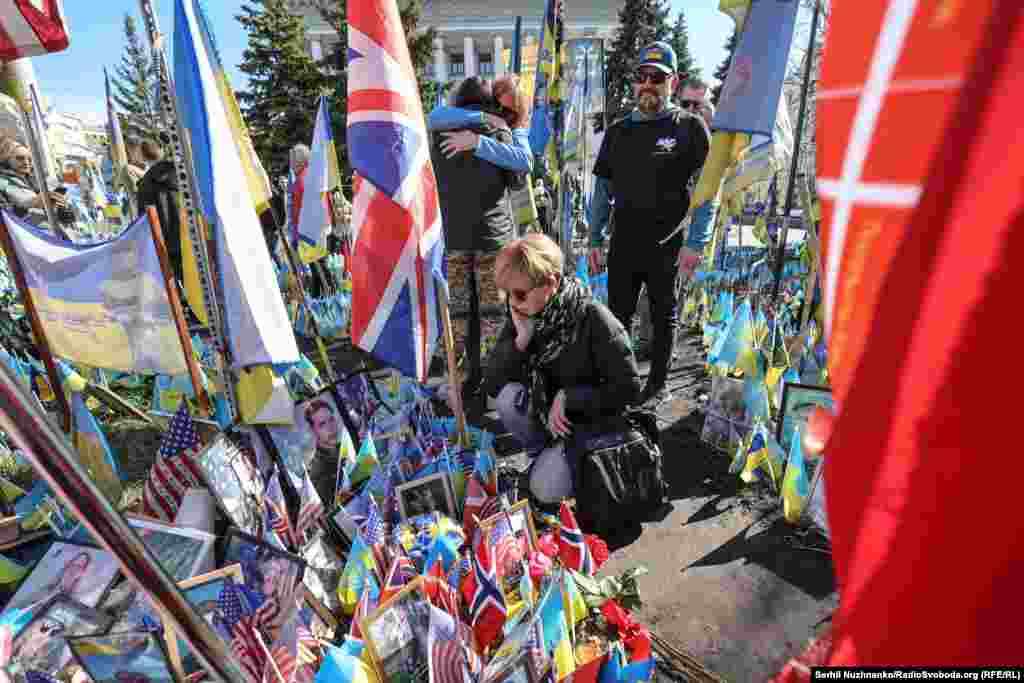 People gather around portraits of fallen volunteers during the March 14 ceremony.At least 50 Americans, most of them military veterans, are reported to have been killed in Ukraine since Russia's 2022 full-scale invasion.