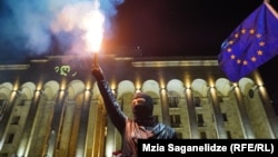 An anti-government protester take part in a demonstration in Tbilisi earlier this month. 